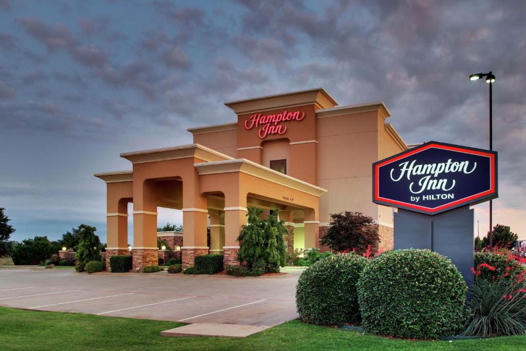 a hampton inn sign in front of a building at Hampton Inn Vernon in Vernon