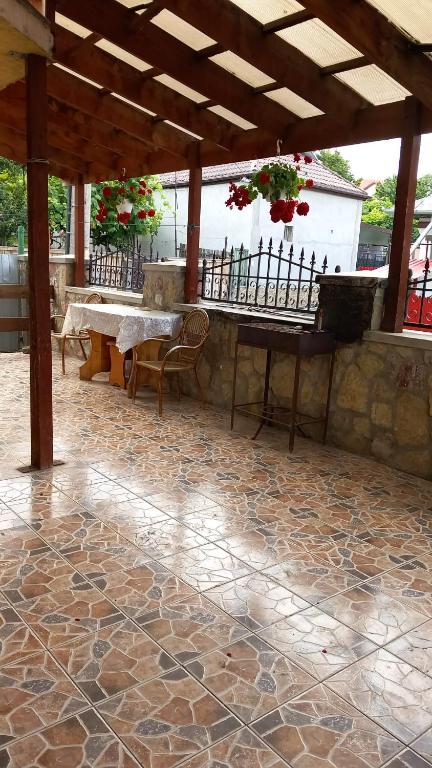 an outdoor patio with a table and a piano at SC Pati-Com FLOREX SRL - CASA ADELA in Tulcea