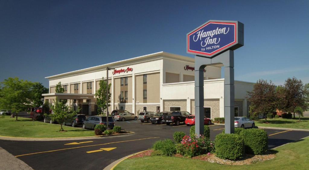 a shopping center with a sign in a parking lot at Hampton Inn South Haven in South Haven