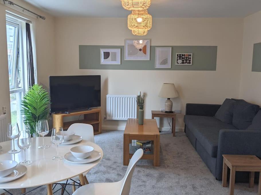 a living room with a table and a couch at Homely 2 bed duplex with a river view in Southampton