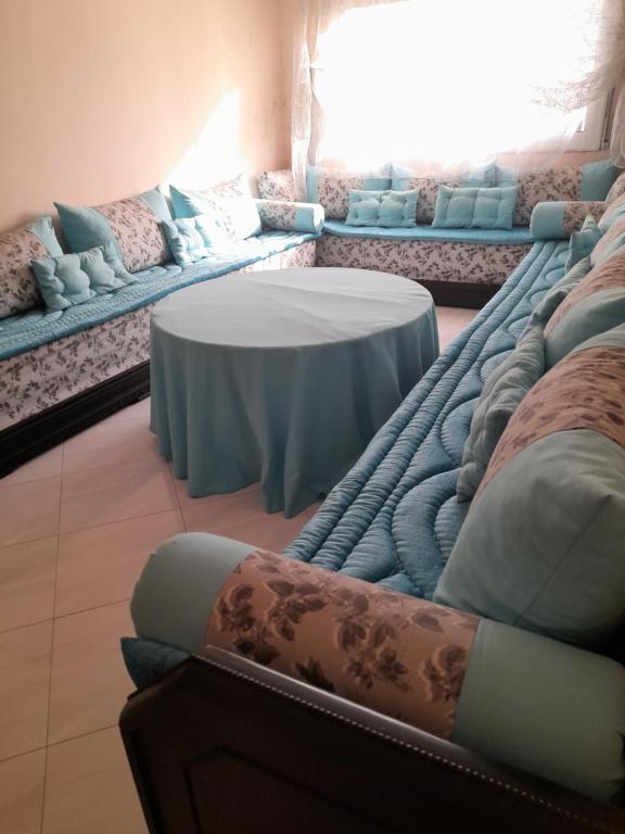 a room with couches and a table in a room at Ajdir in Al Hoceïma
