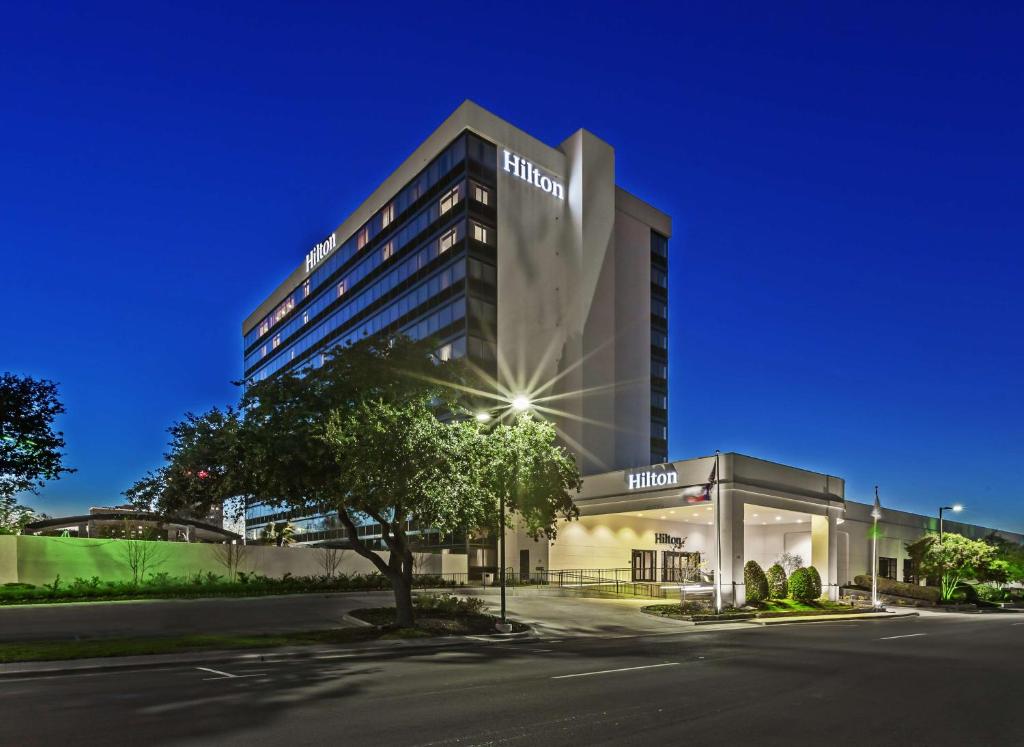 a building with a sign on the side of it at Hilton Waco in Waco