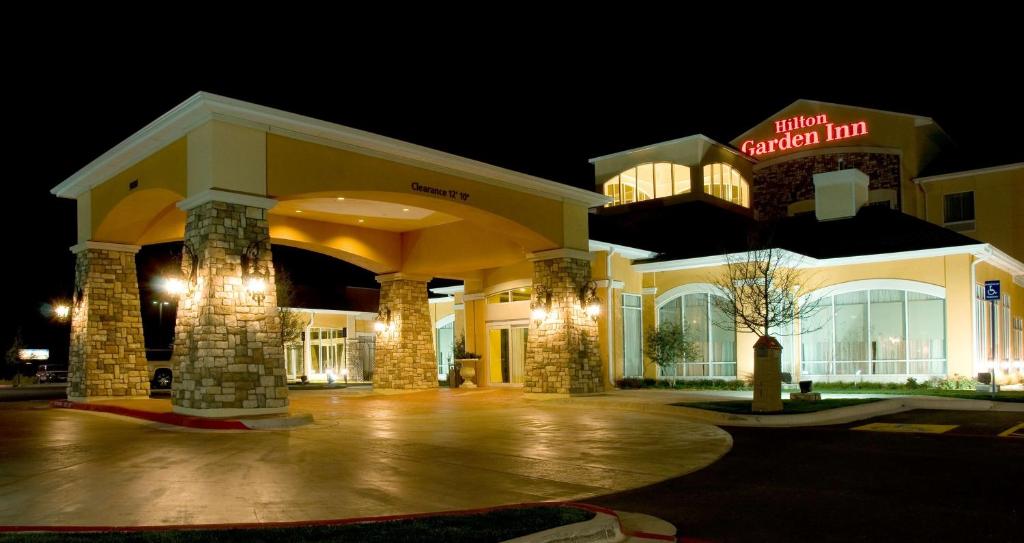 a hotel at night with a sign that reads hotel american inn at Hilton Garden Inn Amarillo in Amarillo