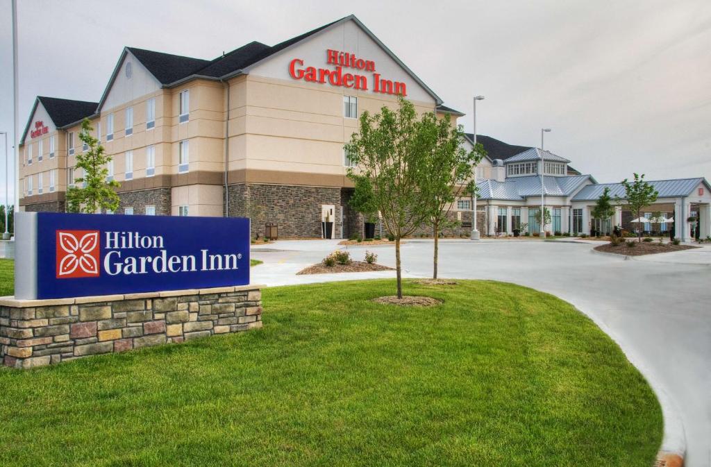 a hotel with a sign in front of a building at Hilton Garden Inn Ames in Ames