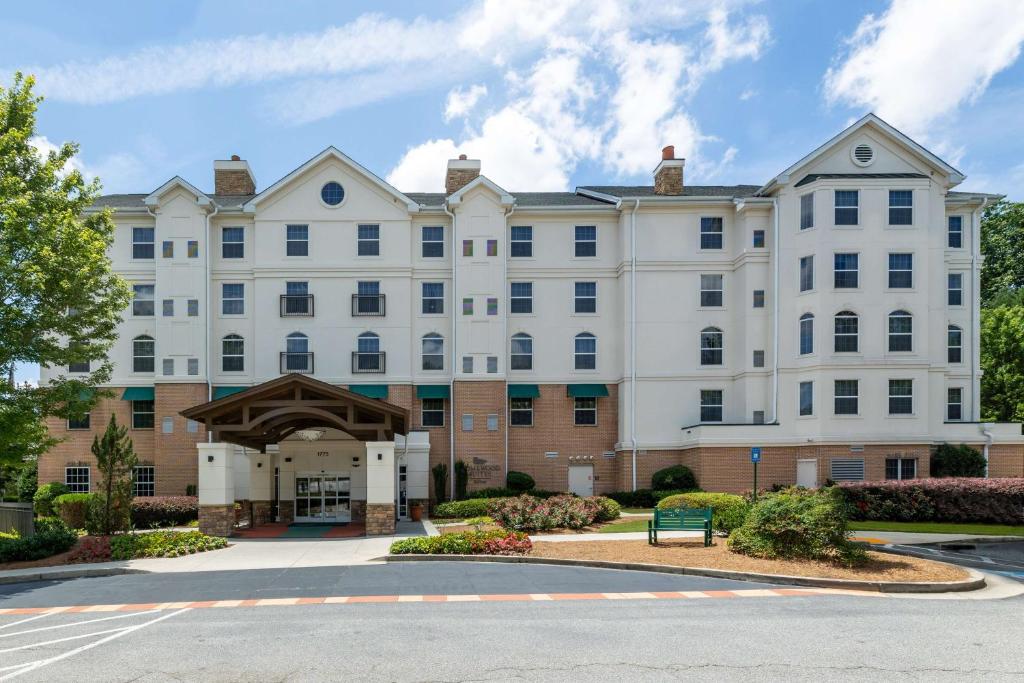 a large white building with a courtyard at Homewood Suites by Hilton Lawrenceville Duluth in Lawrenceville