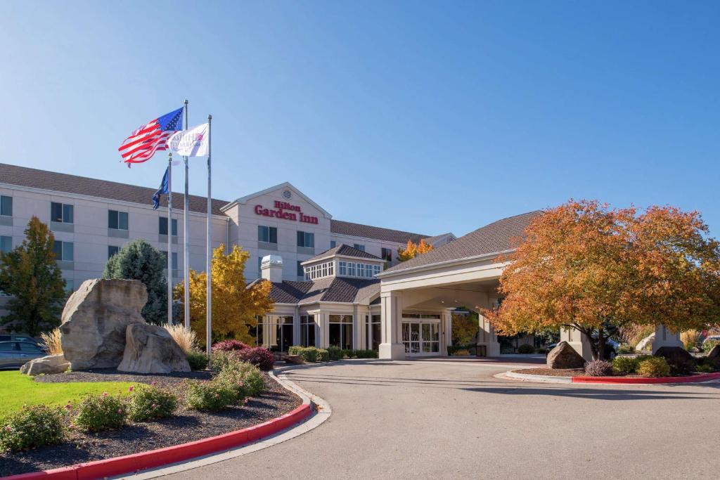 a hotel with an american flag in front of it at Hilton Garden Inn Boise Spectrum in Boise
