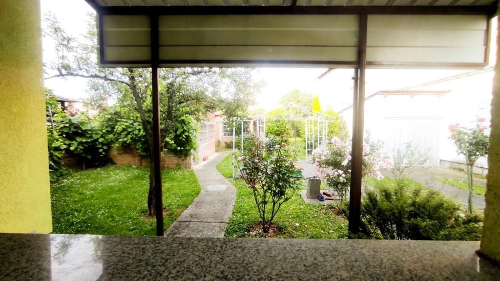 uma vista para um jardim a partir da janela da cozinha de uma casa em Kuća za odmor Proljeće em Dakovo