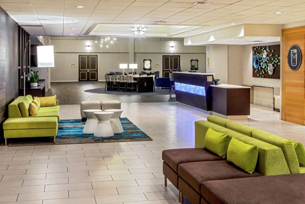 a lobby with couches and a table and a dining room at DoubleTree by Hilton Columbia in Columbia