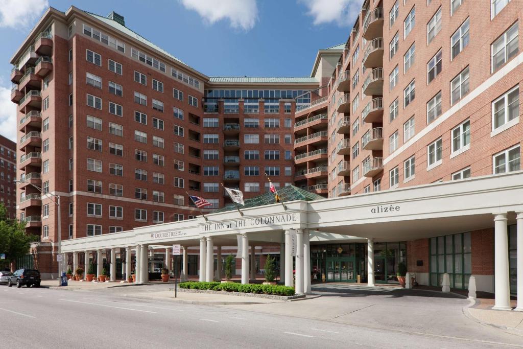 a large brick building with a large building at Inn at the Colonnade Baltimore - A DoubleTree by Hilton Hotel in Baltimore