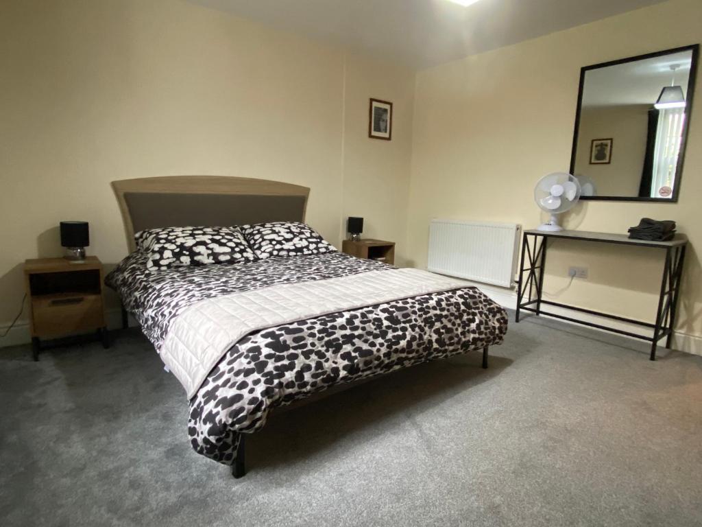 a bedroom with a bed and a desk and a mirror at Well-appointed apartment in New Brighton in New Brighton