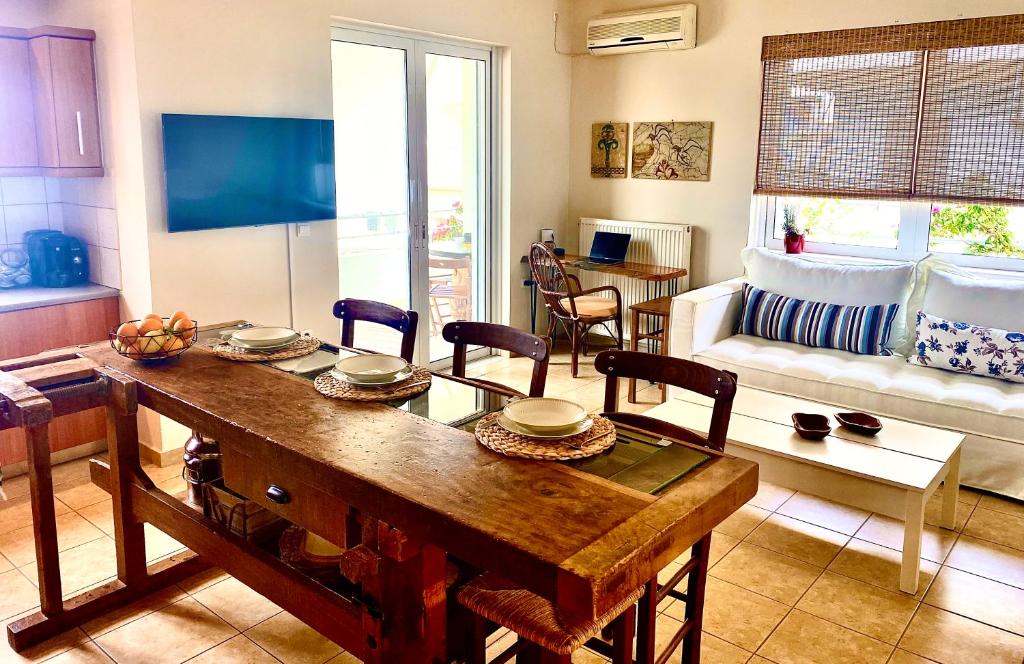 a living room with a wooden table and chairs at Atreas’ Art Studio in Chania Town