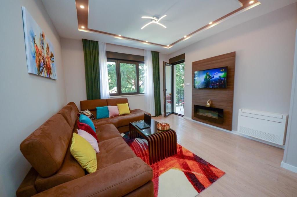 a living room with a couch and a tv at Pine apartment in the center in Trebinje