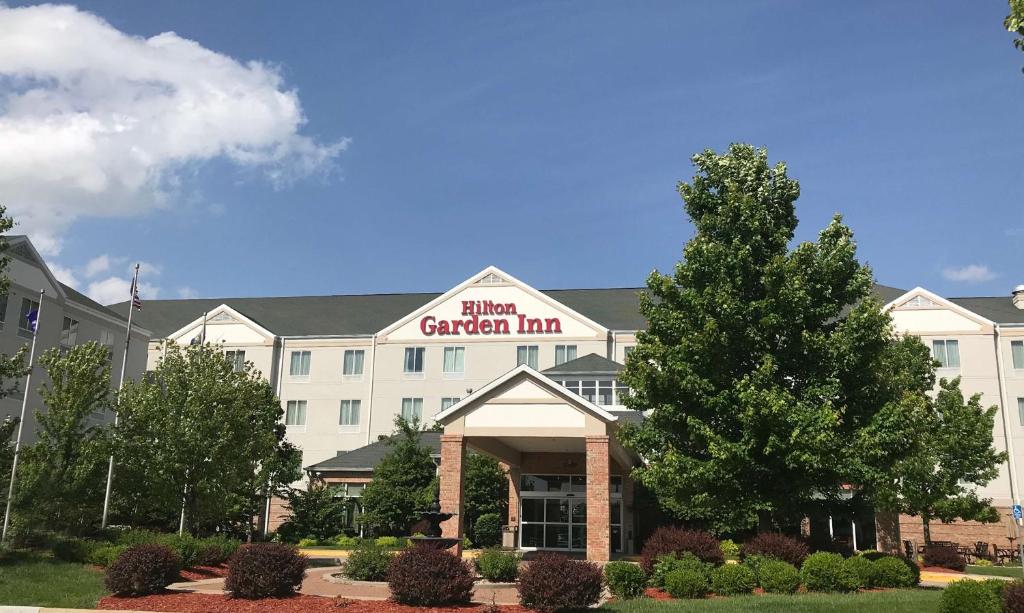 a hotel with a sign on the front of a building at Hilton Garden Inn Columbia in Columbia