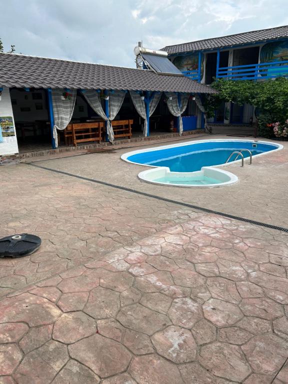 a swimming pool in front of a building at Casa Iris Murighiol in Murighiol