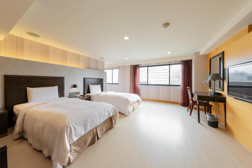 Postel nebo postele na pokoji v ubytování Shihzuwan Hotel – Kaohsiung Station