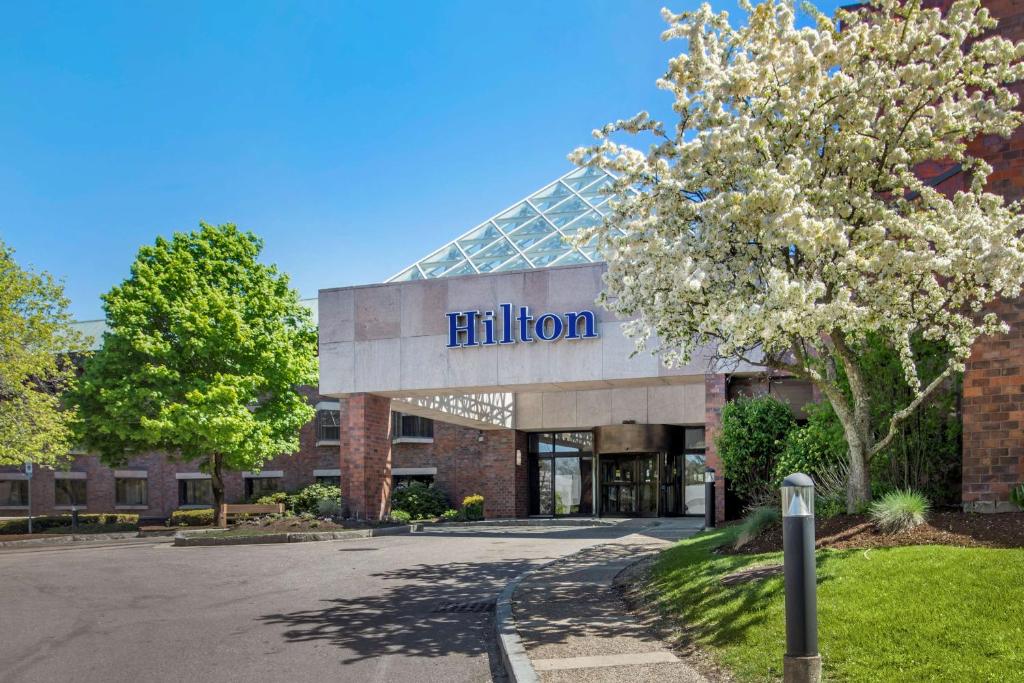a building with aidium sign on the front of it at Hilton Boston Dedham in Dedham