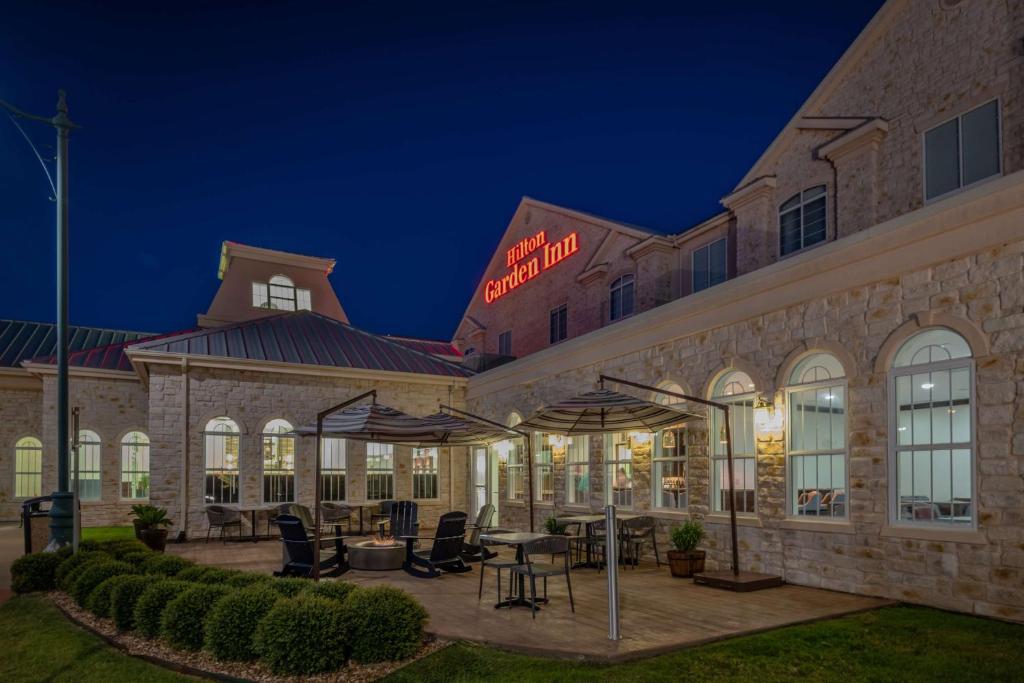 a rendering of the exterior of a hotel at night at Hilton Garden Inn Granbury in Granbury