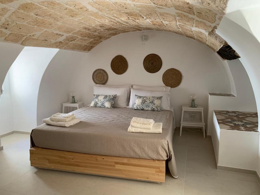 a bedroom with a large bed with a stone ceiling at Nonna Rosa Maison in Monopoli