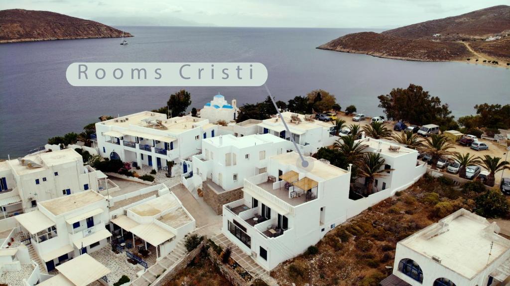 an aerial view of homes in front of the water at Cristi Rooms in Livadi
