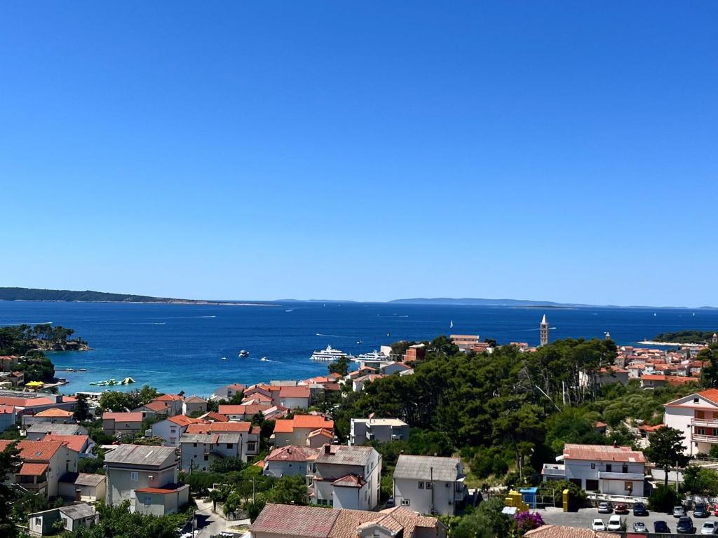 a view of a city and the ocean at D&M APARTMENTS in Rab