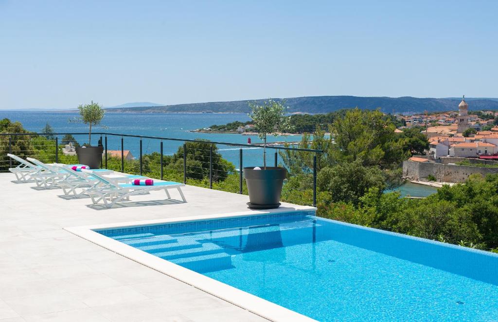 a swimming pool with a view of the water at Unique Apartment with private pool in Krk