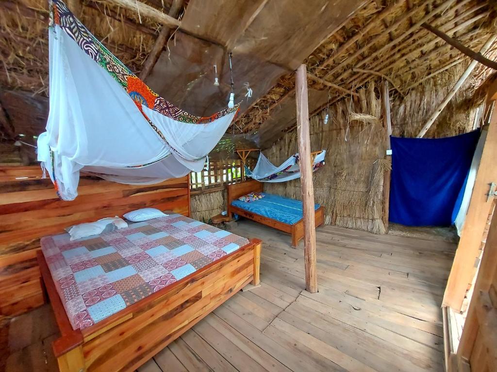 a room with a bed and a hammock in it at Mountain Bikes House in Moshi