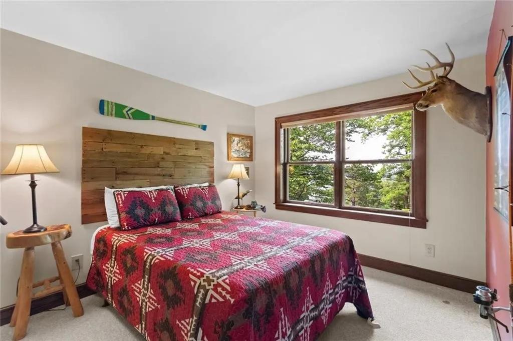 a bedroom with a large bed and a window at White River Mountain Manor- Million dollar view in Eureka Springs