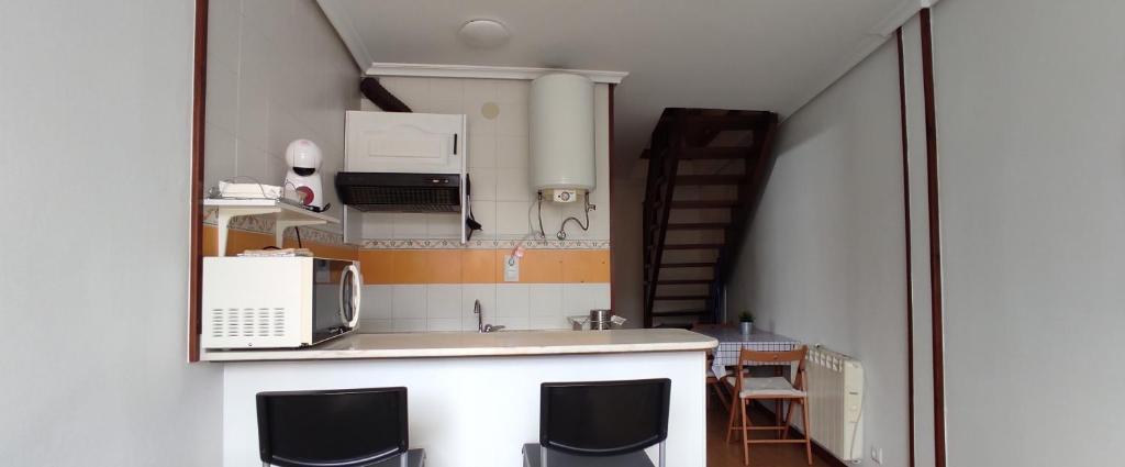 A kitchen or kitchenette at Apartamentos El Jornu