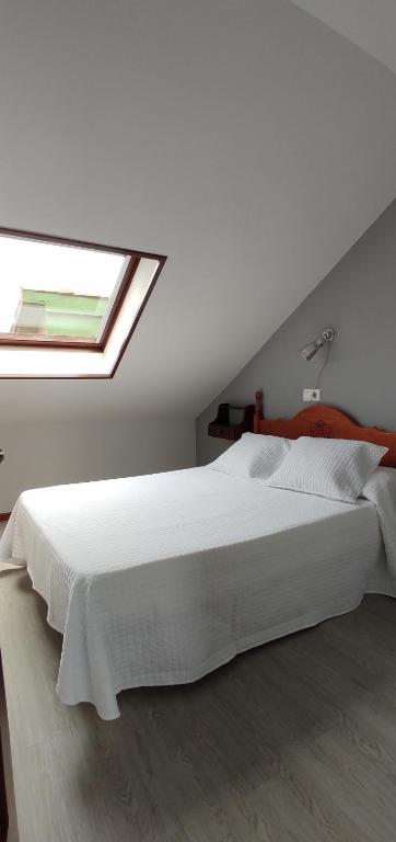 A bed or beds in a room at Apartamentos El Jornu