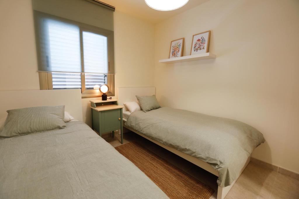 A bed or beds in a room at Mediterranean City