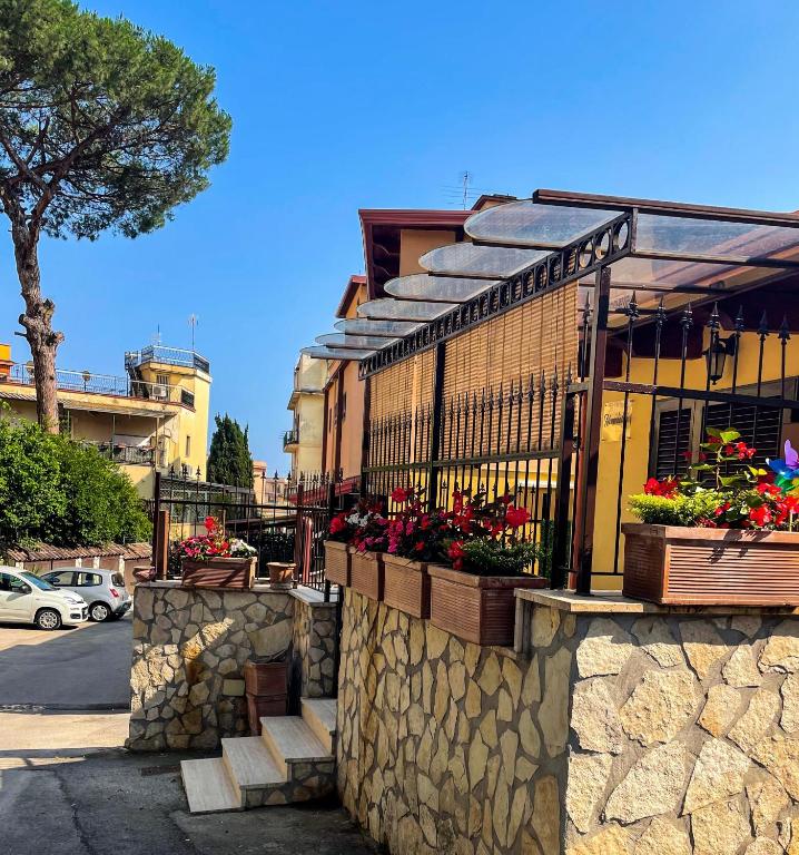 a building with flower boxes on a stone wall at Casa Nennella con Parcheggio Auto gratuito in Loco in Naples