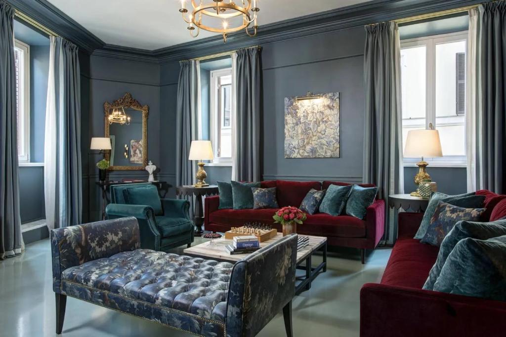 a living room with blue walls and red couches at Luxury Flat in London