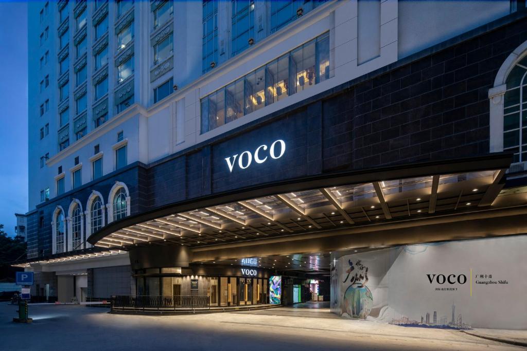 a view of a voco building at night at voco Guangzhou Shifu, an IHG Hotel - Free shuttle between hotel and Exhibition Center during Canton Fair & Exhibitor registration Counter in Guangzhou