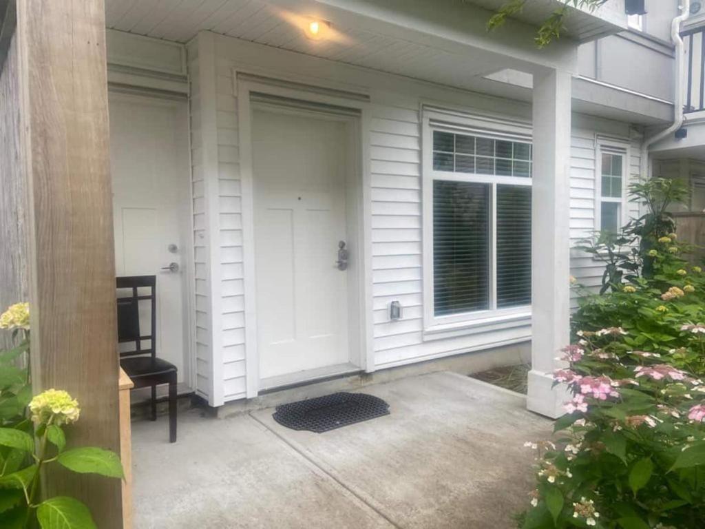 a front porch of a house with a white door at Spacious Room to Stay In in Surrey