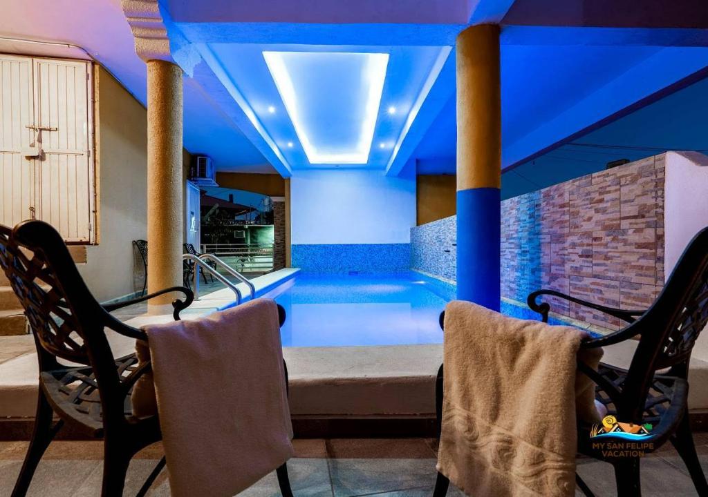 a swimming pool in a house with two chairs at San Felipe rental - One block to San Felipe Malecon in San Felipe