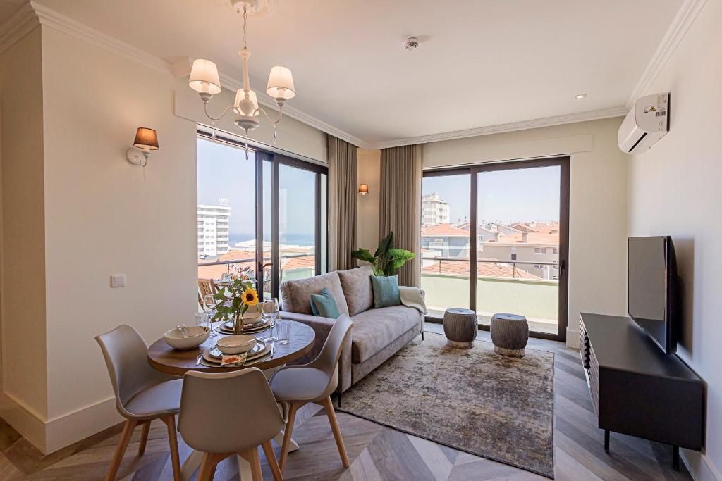 a living room with a couch and a table at 19 Nineteen Suites - Espinho in Espinho