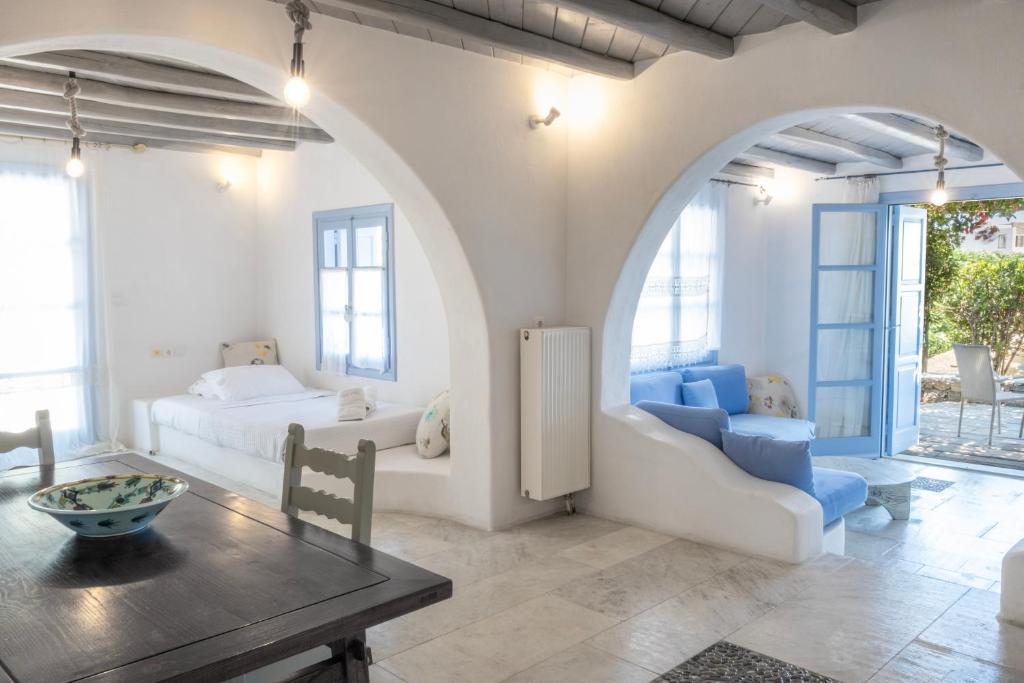 a living room with a bed and a table at Nama Villas in Super Paradise Beach