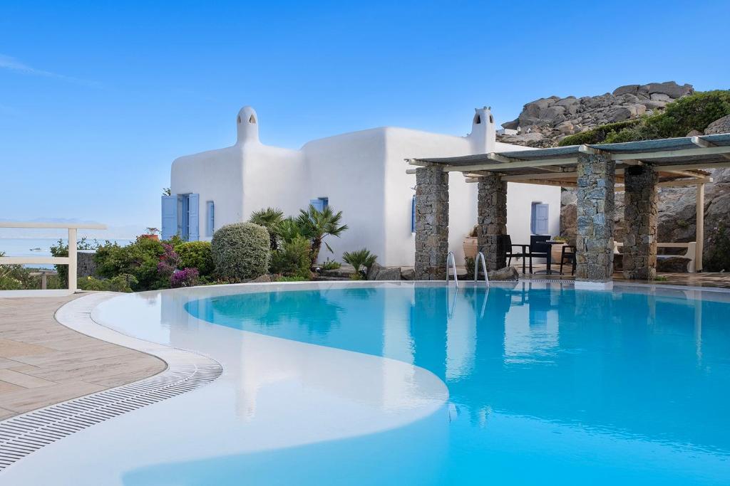 a large swimming pool in front of a building at Nama Villas in Super Paradise Beach