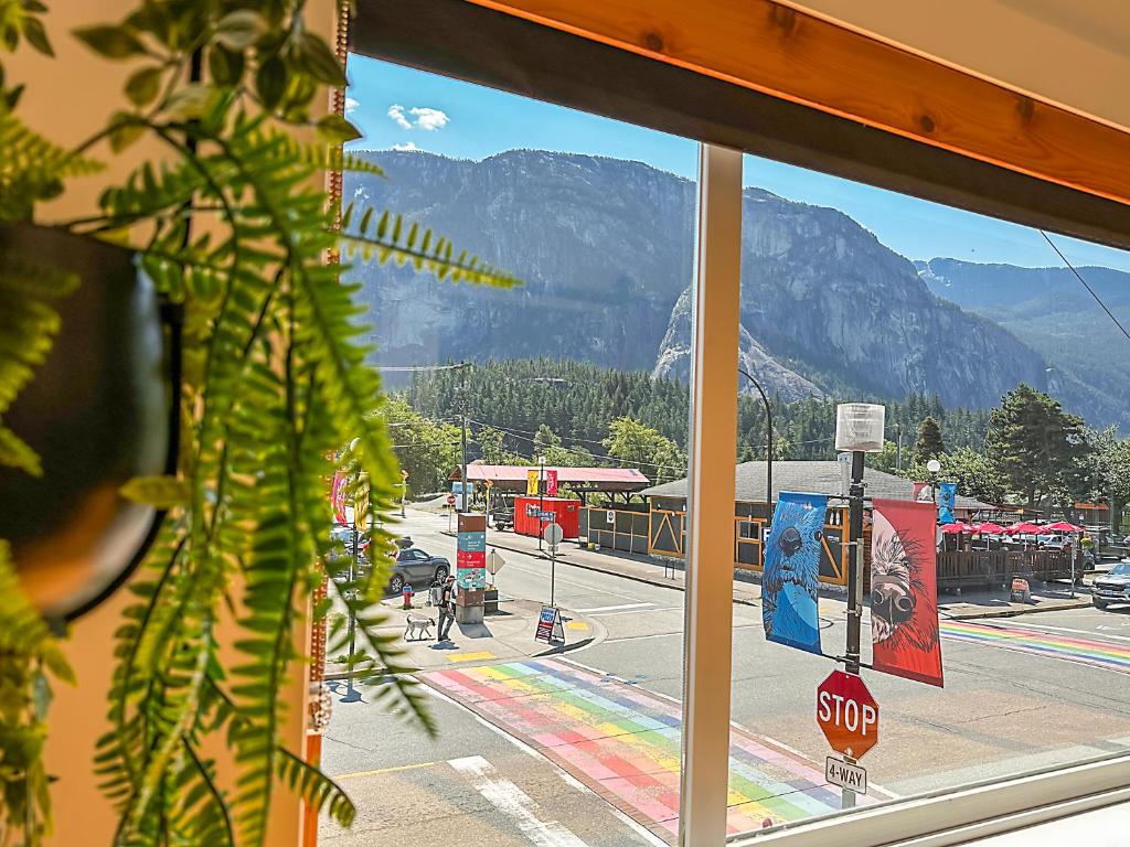 a view from a store window of a street and mountains at Crash Hotel Squamish in Squamish