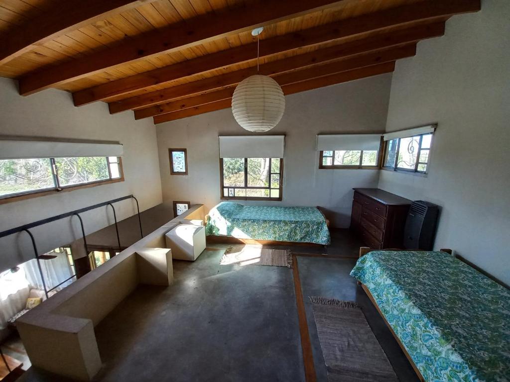 a bedroom with two beds and a couch and windows at Casas Piedra del Sol in Costa del Este