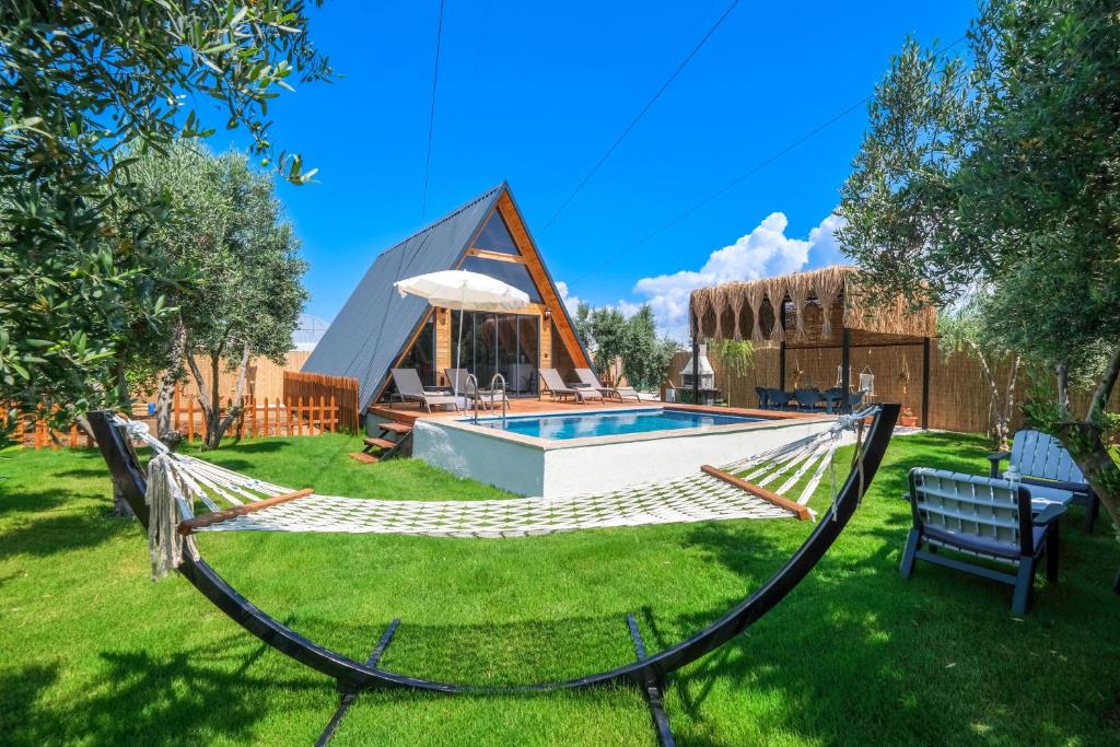 a hammock in a yard next to a swimming pool at AsseVilla in Fethiye