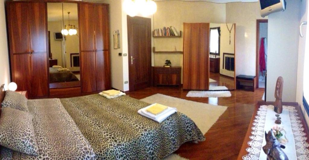 a bedroom with a large bed with two towels on it at B&B Le Tre Grazie in San Martino di Lupari