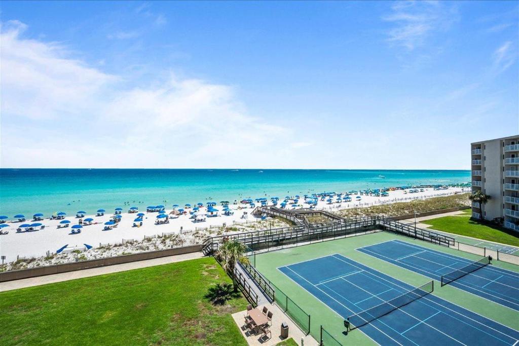 an aerial view of a tennis court and the beach at Holiday Surf and Racquet Unit 520 in Destin