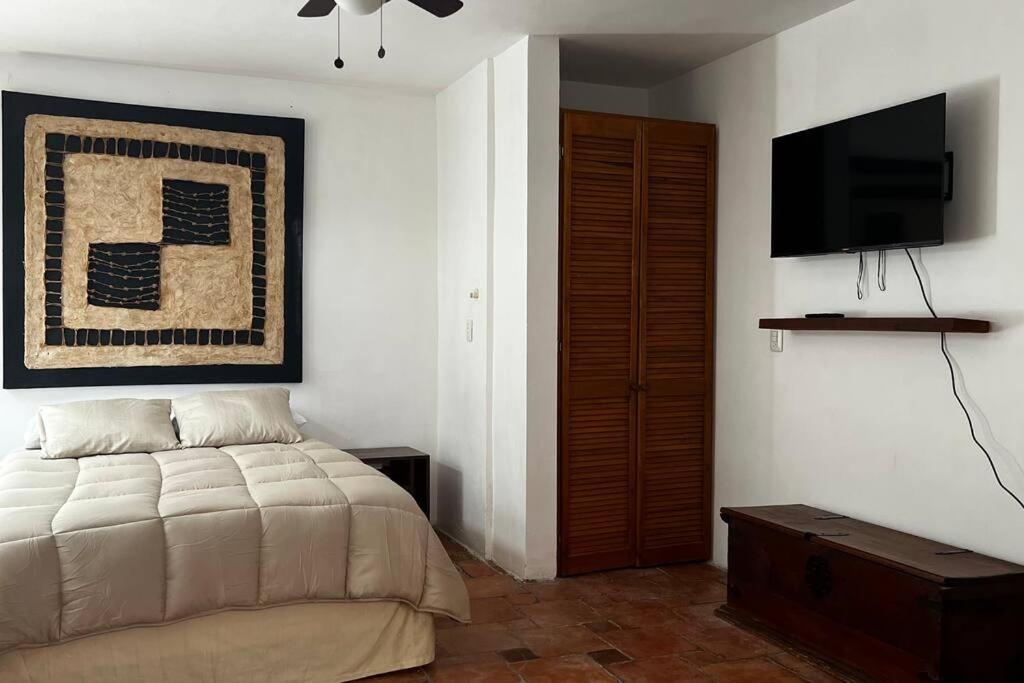 a bedroom with a bed and a flat screen tv at Yaya’s Place 1 in Saltillo