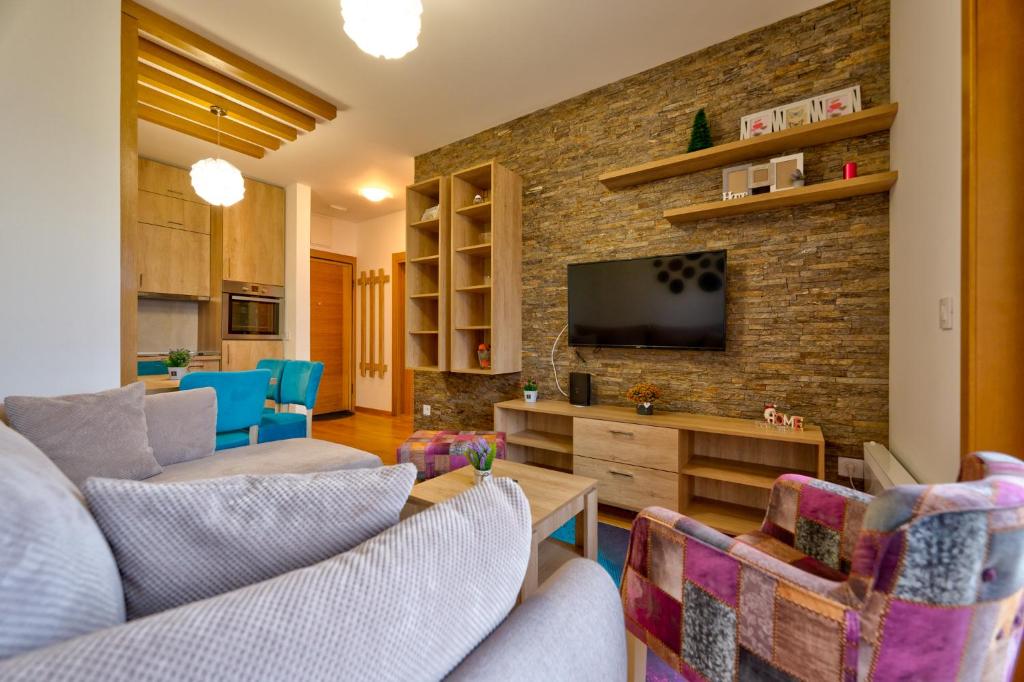 a living room with two couches and a tv at S35, vila Elsa 1 in Zlatibor