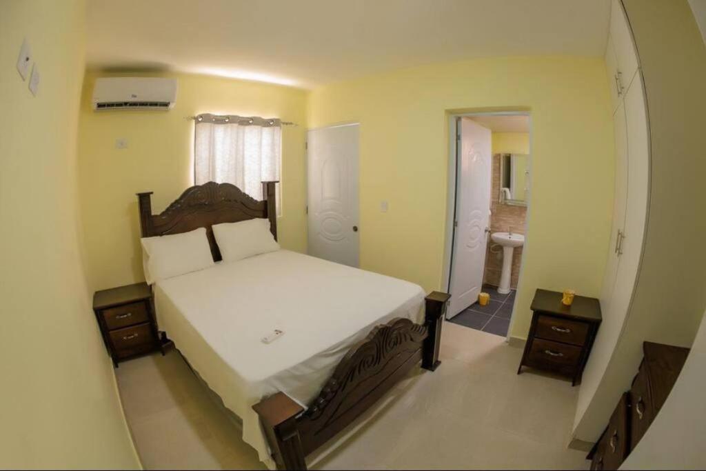 a bedroom with a large bed and a bathroom at Hotel La Playa in Santa Cruz de Barahona
