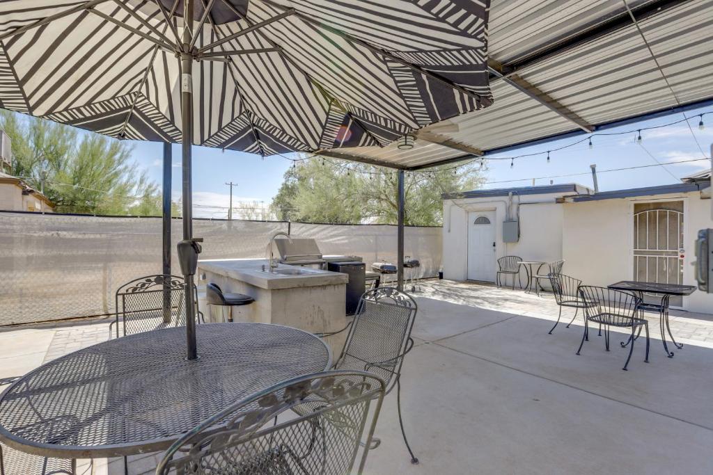 a patio with tables and chairs under a roof at Pet-Friendly Phoenix Vacation Rental Near Downtown in Phoenix