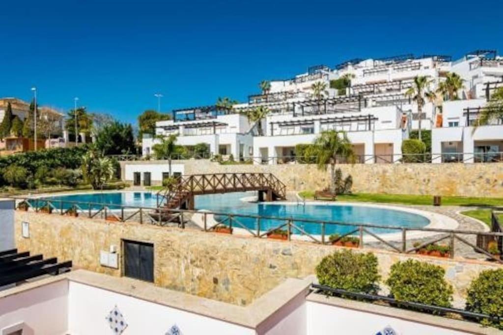 a resort with two swimming pools and buildings at Dúplex de Lujo Marbella Golf in Marbella
