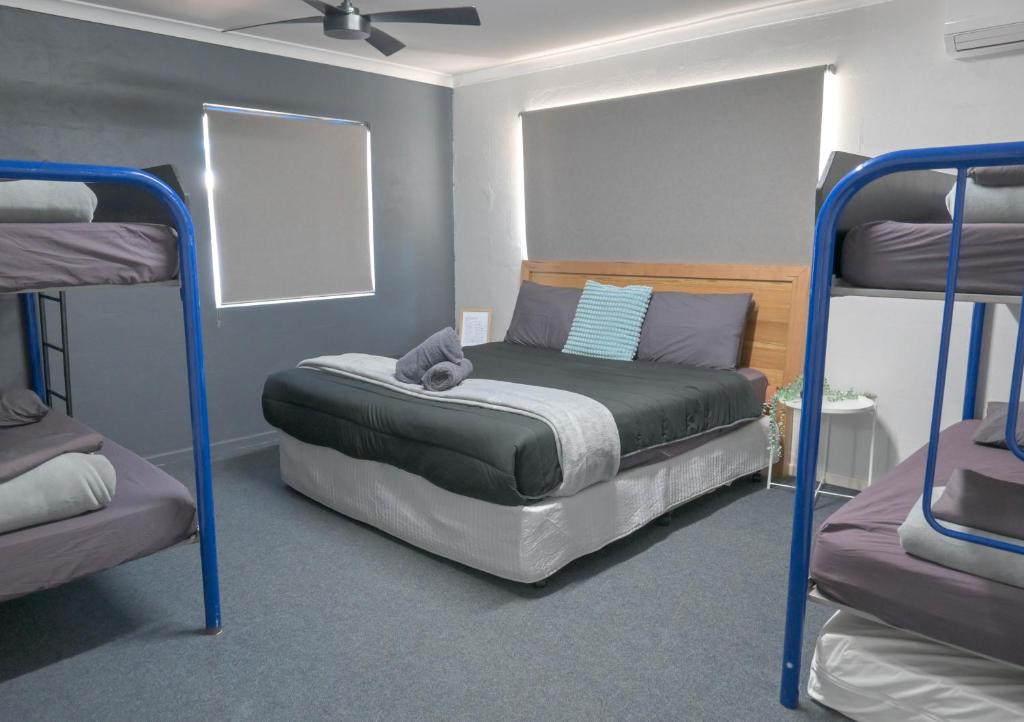 a bedroom with two bunk beds in a room at Kalbarri Inn in Kalbarri