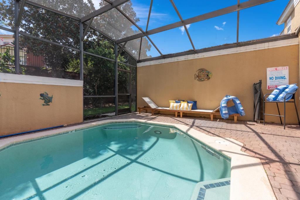 a swimming pool in a building with a glass roof at Wish Upon A Splash - Family Villa - 3BR - Private Pool - Disney 4 miles in Kissimmee
